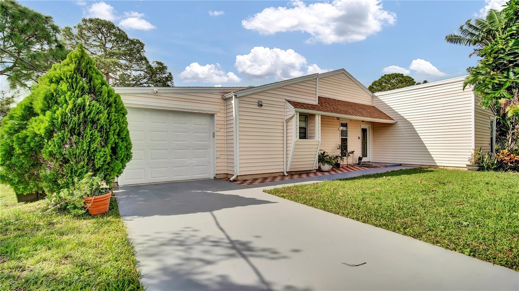 ranch-style house with a front lawn and a garage