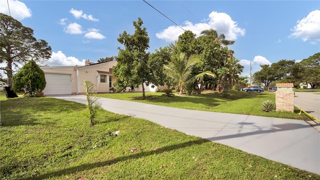 view of front of house with a garage and a front lawn