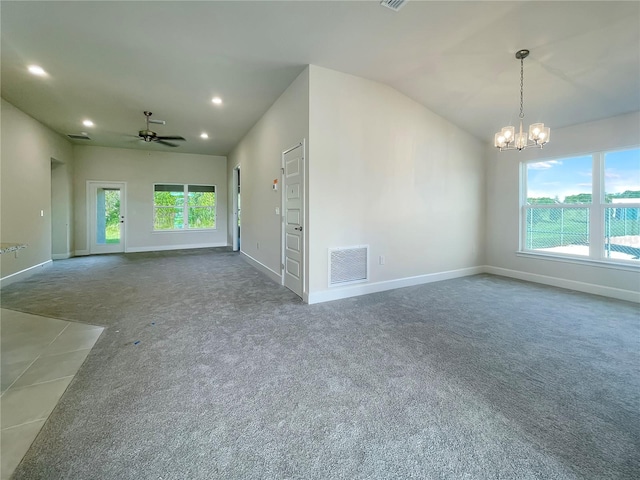 carpeted empty room with lofted ceiling and ceiling fan with notable chandelier