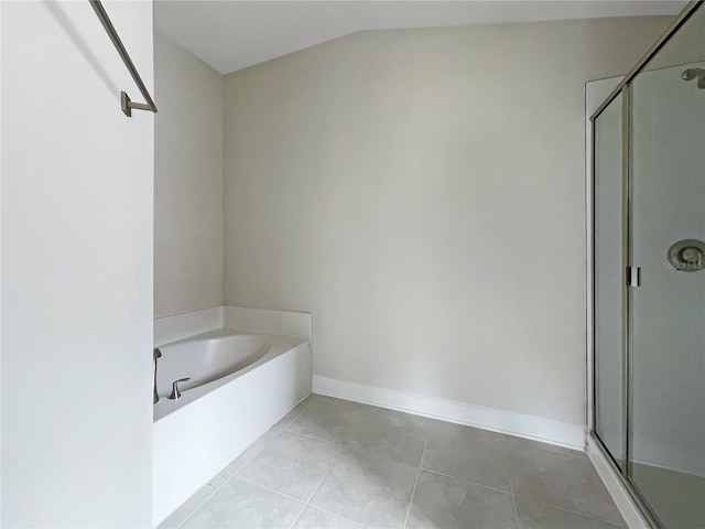 4394 Sagefield Dr, Harmony, FL 34773 - full bathroom featuring a shower stall, a bath, tile patterned flooring, baseboards, and lofted ceiling