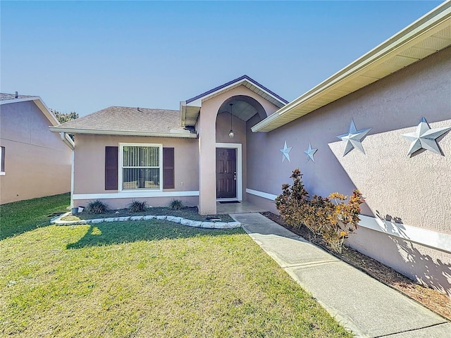 property entrance with a yard