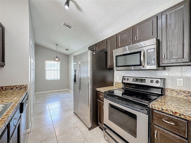 kitchen featuring decorative backsplash, dark brown cabinets, stainless steel appliances, vaulted ceiling, and light tile patterned floors