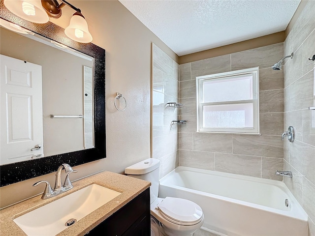 full bathroom with vanity, a textured ceiling, toilet, and tiled shower / bath