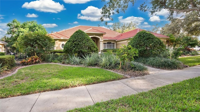 mediterranean / spanish-style house with a front lawn