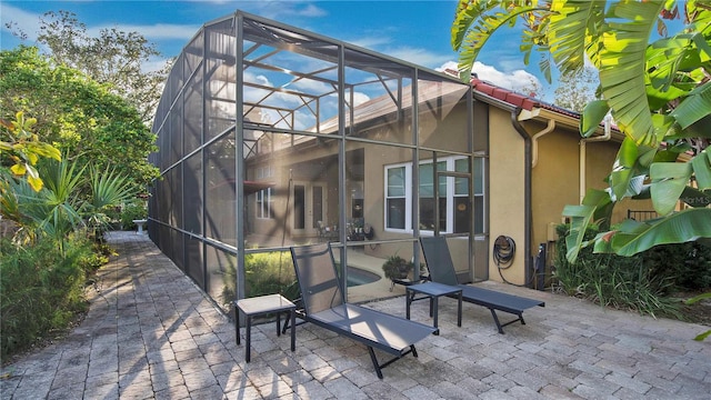 rear view of house featuring a patio area and a lanai