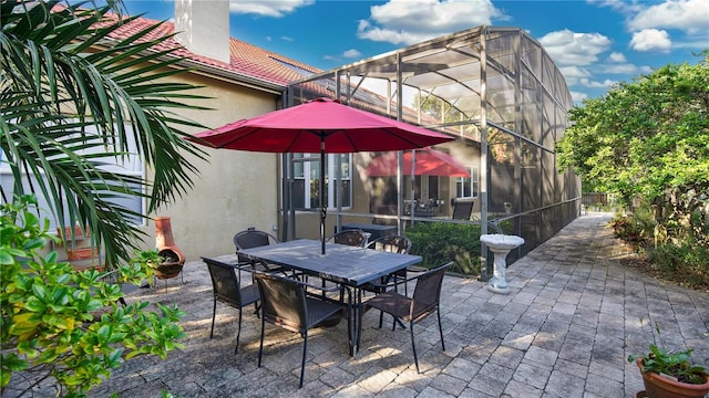 view of patio with glass enclosure