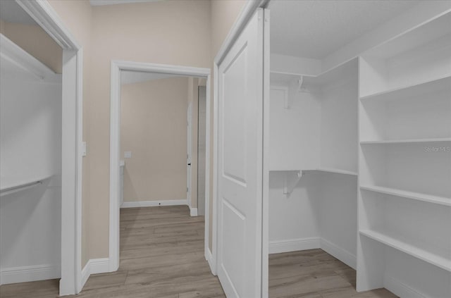 walk in closet featuring light wood-type flooring