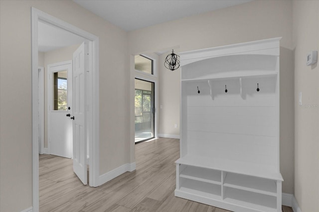 mudroom featuring light hardwood / wood-style floors and an inviting chandelier