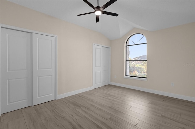 unfurnished bedroom with lofted ceiling, light hardwood / wood-style flooring, and ceiling fan