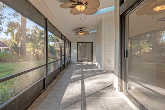 unfurnished sunroom featuring vaulted ceiling and ceiling fan