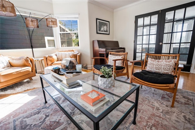 sitting room featuring french doors, ornamental molding, and hardwood / wood-style flooring