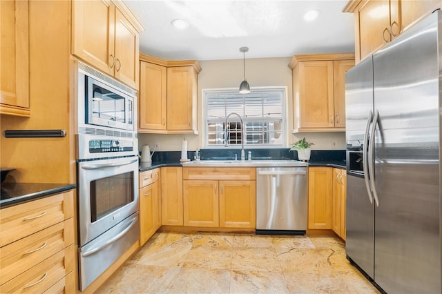 kitchen with light brown cabinets, pendant lighting, and appliances with stainless steel finishes