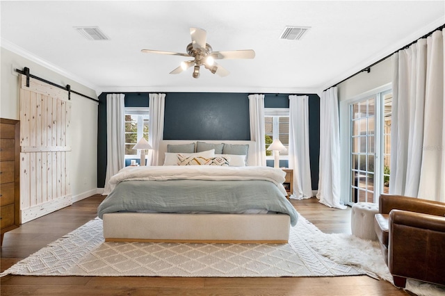 bedroom with multiple windows, ceiling fan, and wood-type flooring