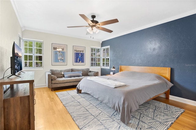 bedroom with ceiling fan, light wood-type flooring, and crown molding