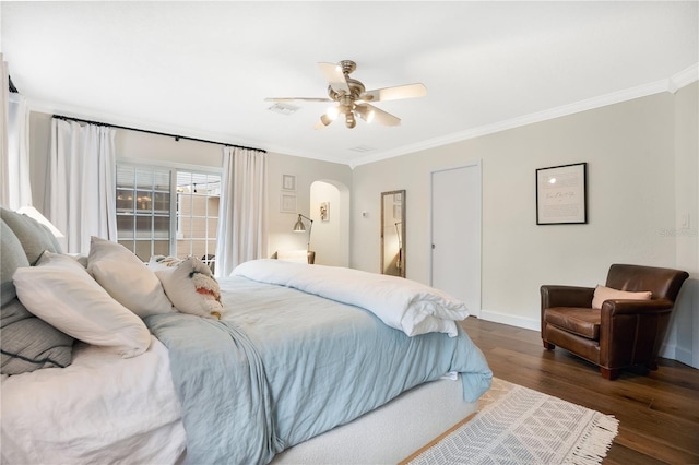 bedroom featuring ceiling fan, dark hardwood / wood-style floors, and ornamental molding