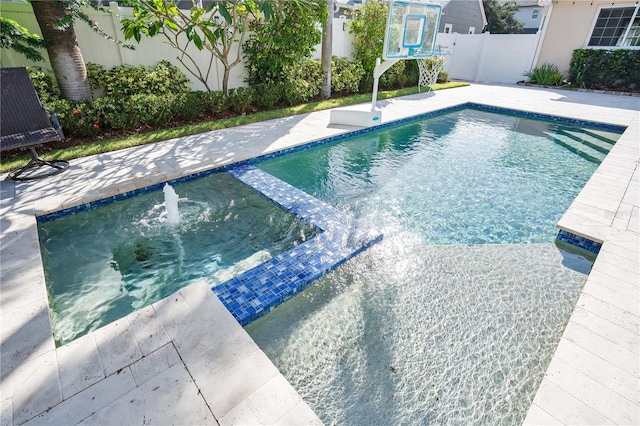 view of swimming pool with an in ground hot tub