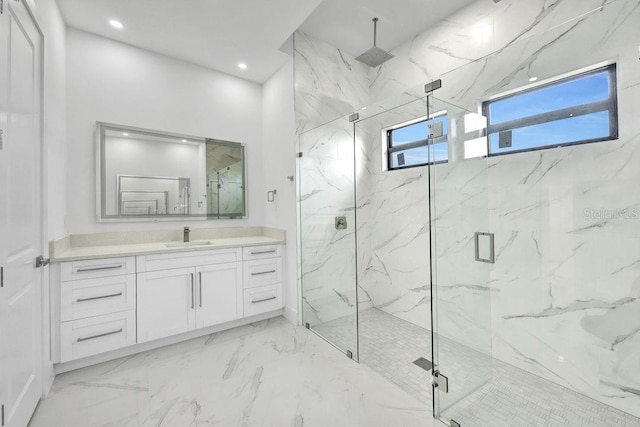 bathroom with vanity and a shower with door