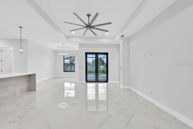 unfurnished room with french doors, a tray ceiling, and ceiling fan