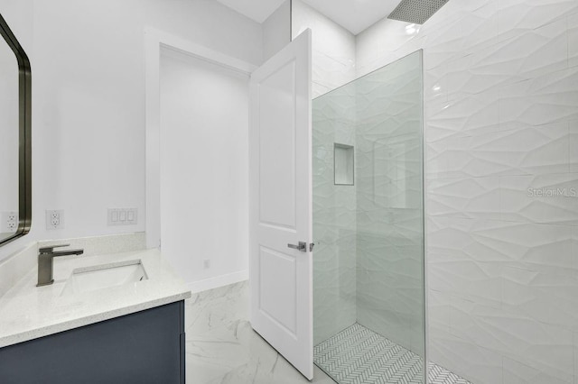 bathroom featuring vanity and tiled shower