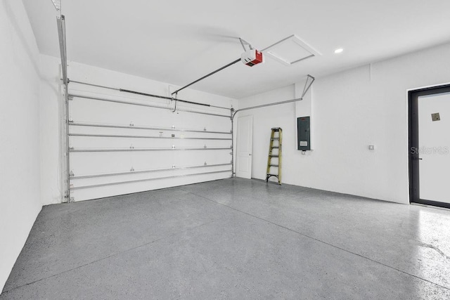 garage with electric panel and a garage door opener