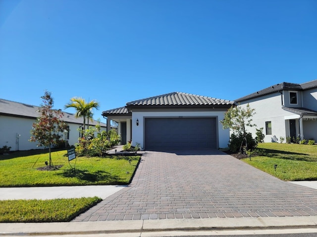 view of front facade with a front yard and a garage