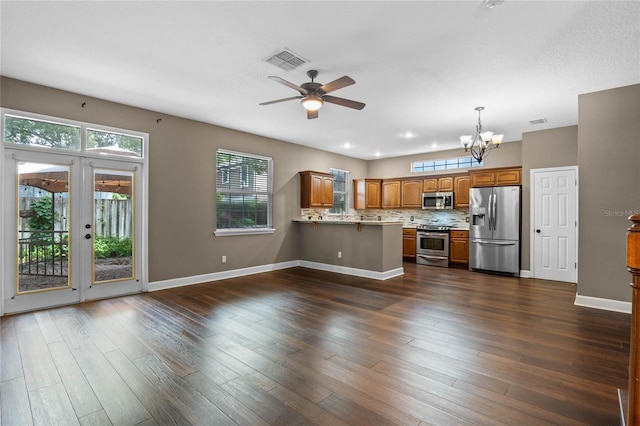 kitchen with pendant lighting, kitchen peninsula, stainless steel appliances, and dark wood-type flooring