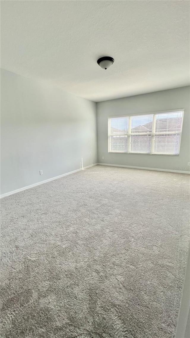 carpeted spare room with a textured ceiling