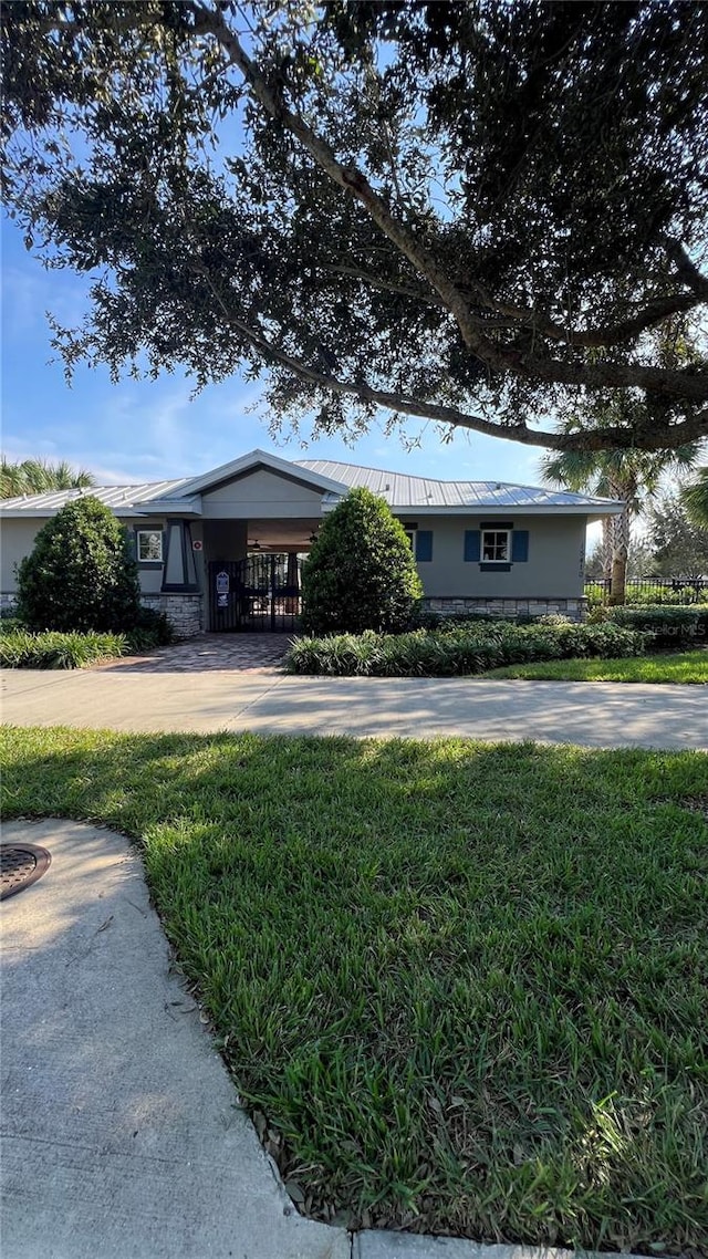 exterior space featuring a front lawn and a carport