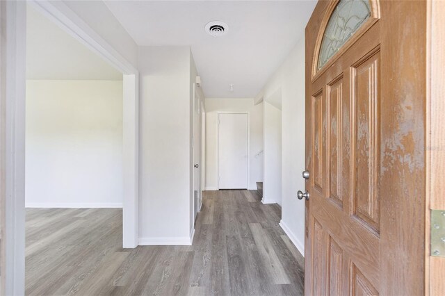 hall with hardwood / wood-style floors