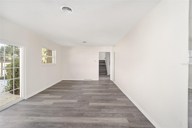 empty room with dark hardwood / wood-style flooring