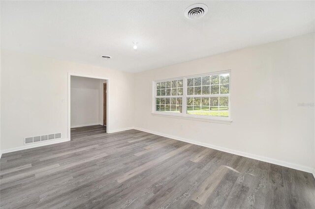 empty room featuring dark wood-type flooring