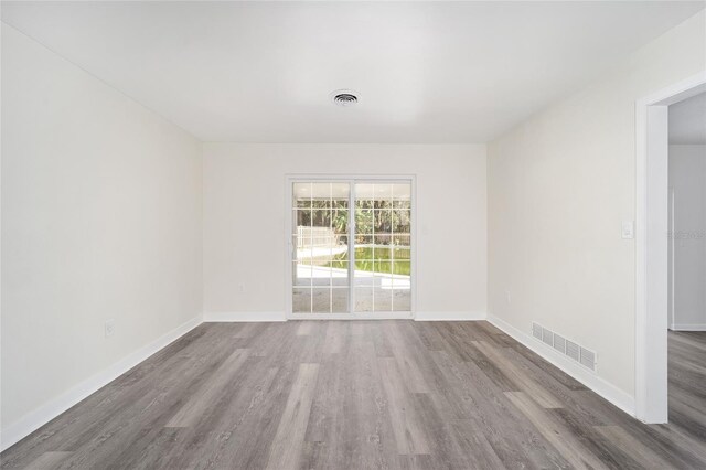 spare room with hardwood / wood-style flooring