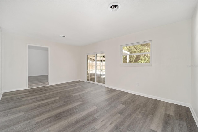 unfurnished room with dark hardwood / wood-style floors