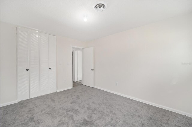 unfurnished bedroom featuring a closet and carpet floors