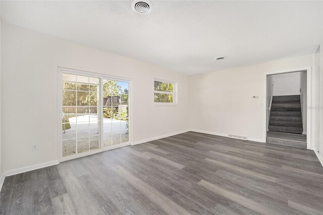 spare room with dark wood-type flooring