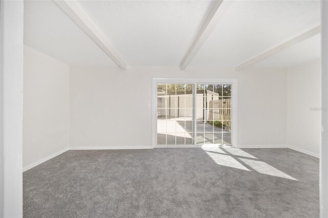 carpeted spare room featuring beam ceiling