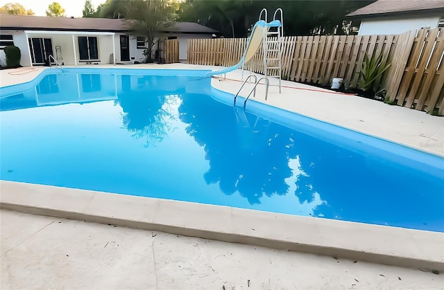 view of swimming pool featuring a water slide