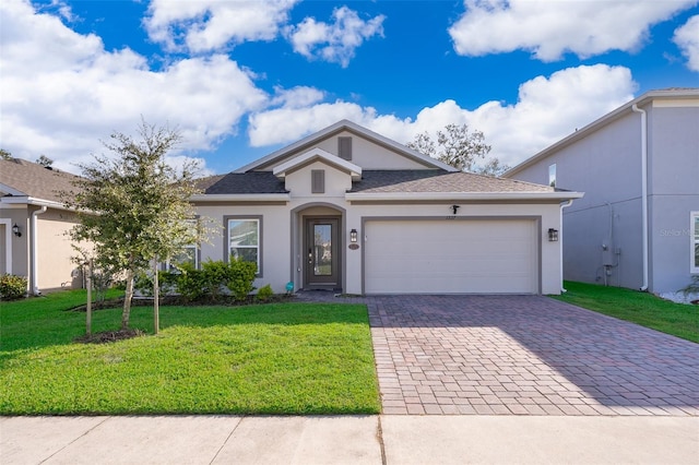 view of front of property with a front yard and a garage