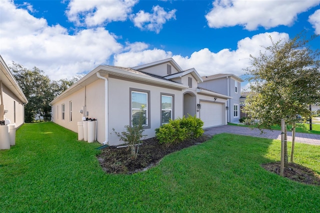 view of front of property with a garage and a front lawn