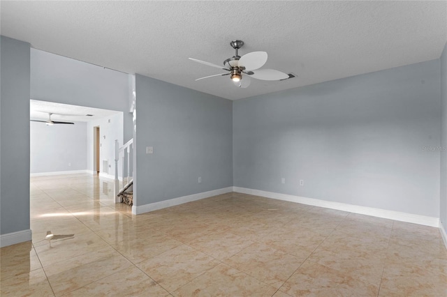 empty room featuring a textured ceiling and ceiling fan