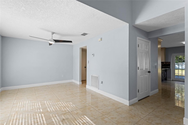 unfurnished room featuring ceiling fan, a textured ceiling, and light tile patterned flooring