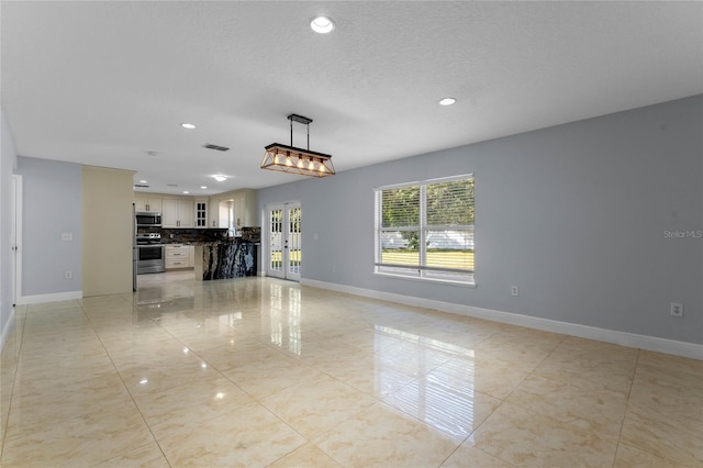 unfurnished living room featuring a textured ceiling