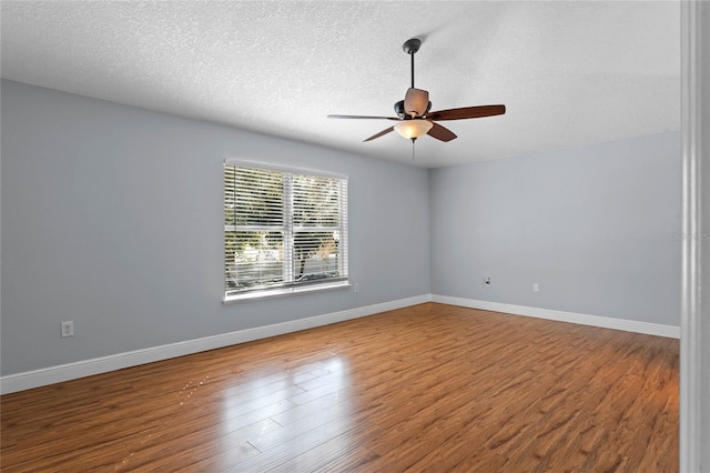 empty room featuring hardwood / wood-style floors, a textured ceiling, and ceiling fan