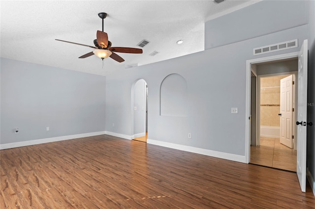 empty room with hardwood / wood-style floors, a textured ceiling, and ceiling fan