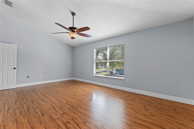 spare room with a textured ceiling, hardwood / wood-style flooring, and ceiling fan