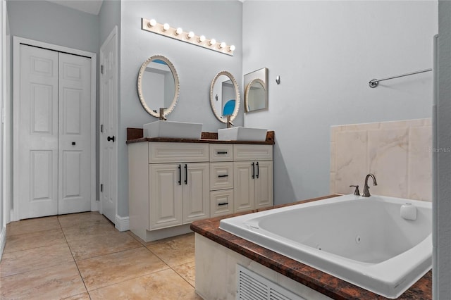 bathroom featuring a bathtub, tile patterned flooring, and vanity