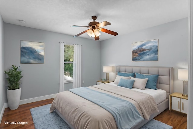 bedroom with ceiling fan and dark hardwood / wood-style floors