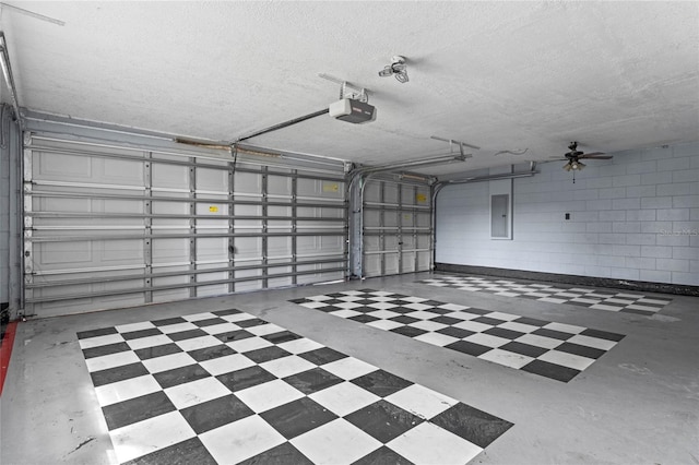 garage featuring ceiling fan, a garage door opener, and electric panel