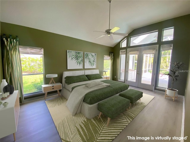 bedroom with multiple windows, light hardwood / wood-style flooring, and access to exterior