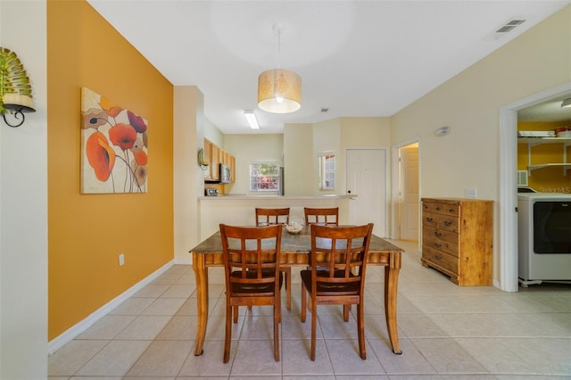 dining room featuring washer / clothes dryer and light tile patterned flooring